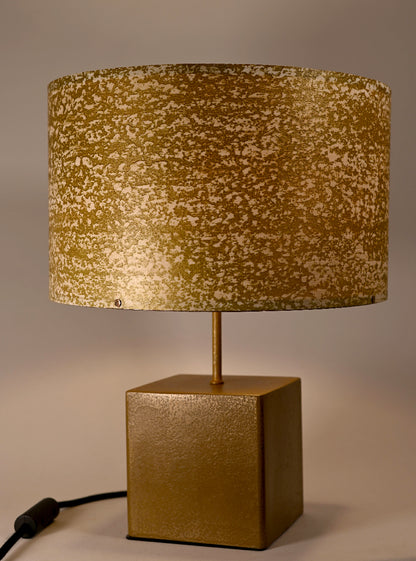 Vue rapprochée de l'abat-jour en feuille de mica blanc teinté or aux reflets dorés lumineux