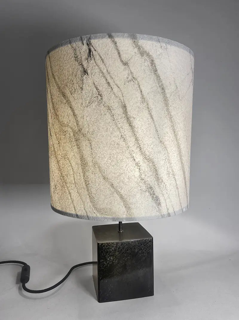 Vue de face de la Lampe Cassini Nova en acier patiné, abat-jour en feuille de  marbre statuaire . Pièce unique de Fabrication française Atelier Maus
